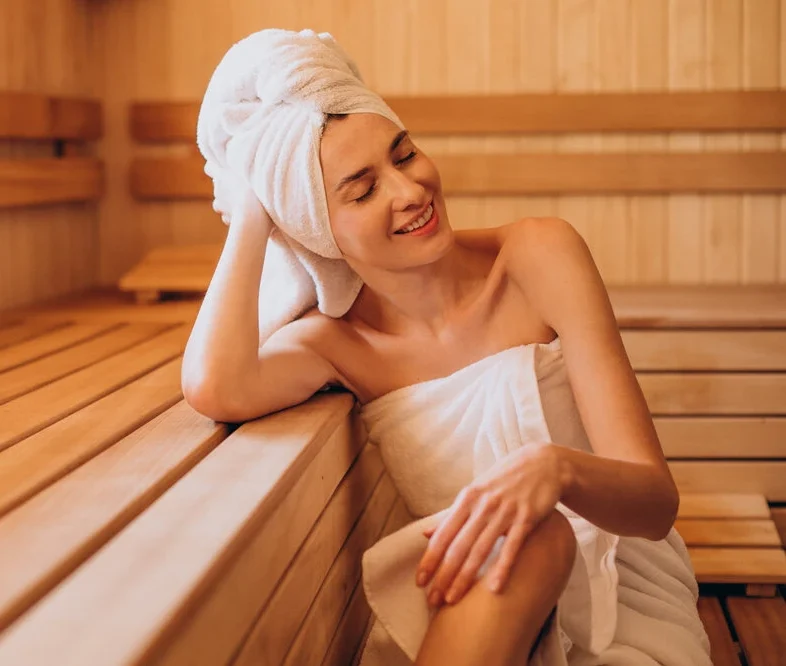 Young woman having rest in sauna alone