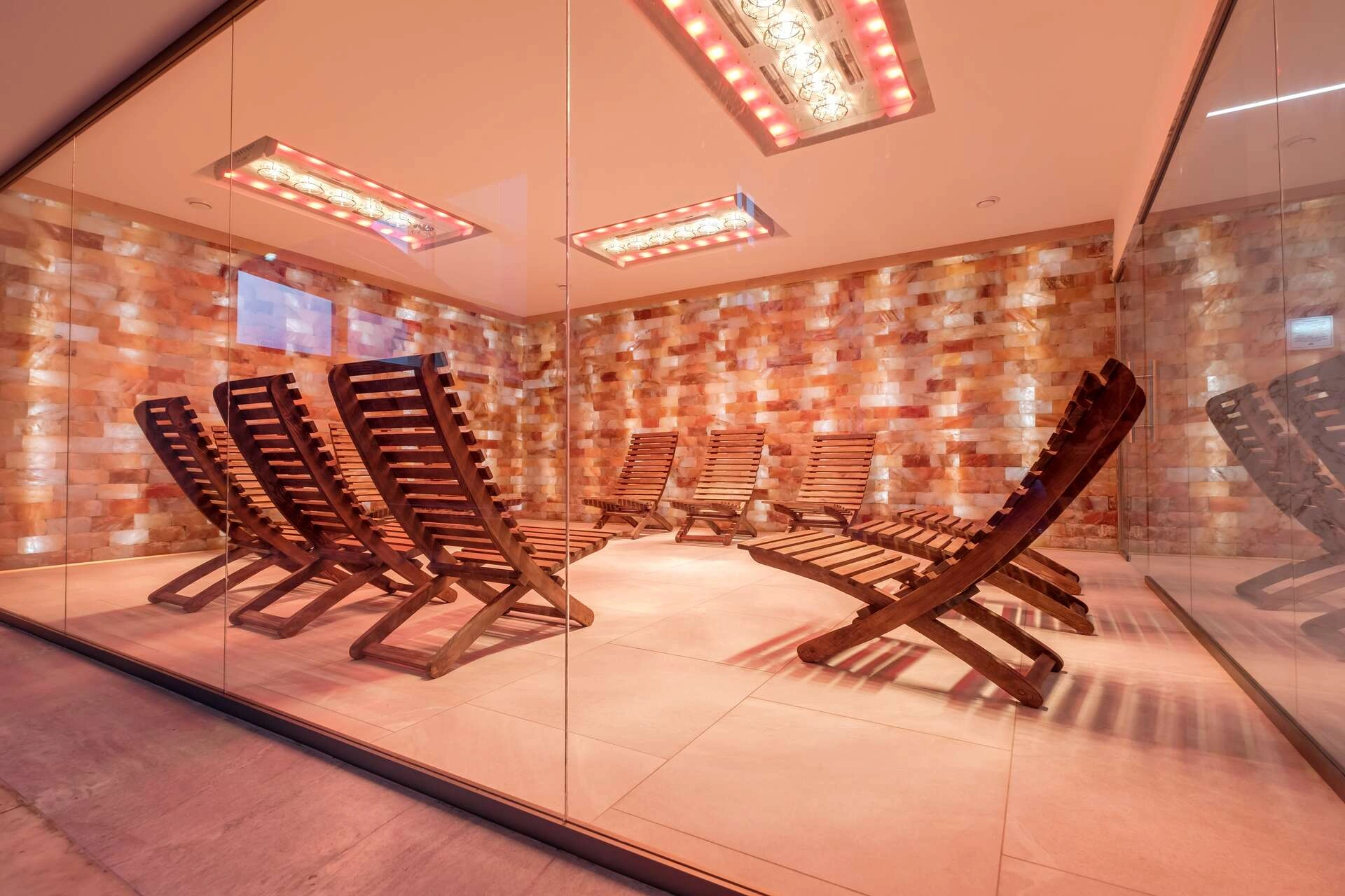interior of modern wellness salt haloper cave with uv light with wooden bench