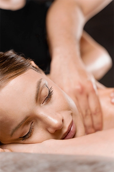 4 hands massage in spa. Two masseurs are making four hands relaxing massage with oil for girl.